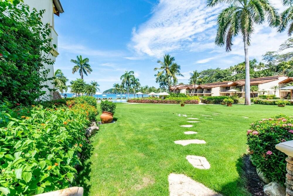 Stylish Split-Level Condo with a Shaded Terrace, Direct Beach Access, and Resort-Style Community Amenities Property Grounds