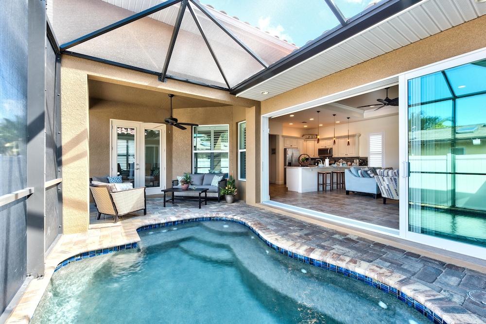Amalfi Vacation Rental: Stylish 3-BR Retreat Steps from Vanderbilt Beach. Relax by the Private Pool and Enjoy Modern Amenities. Ideal for Families with Easy Access to Mercato and Local Attractions Featured Image