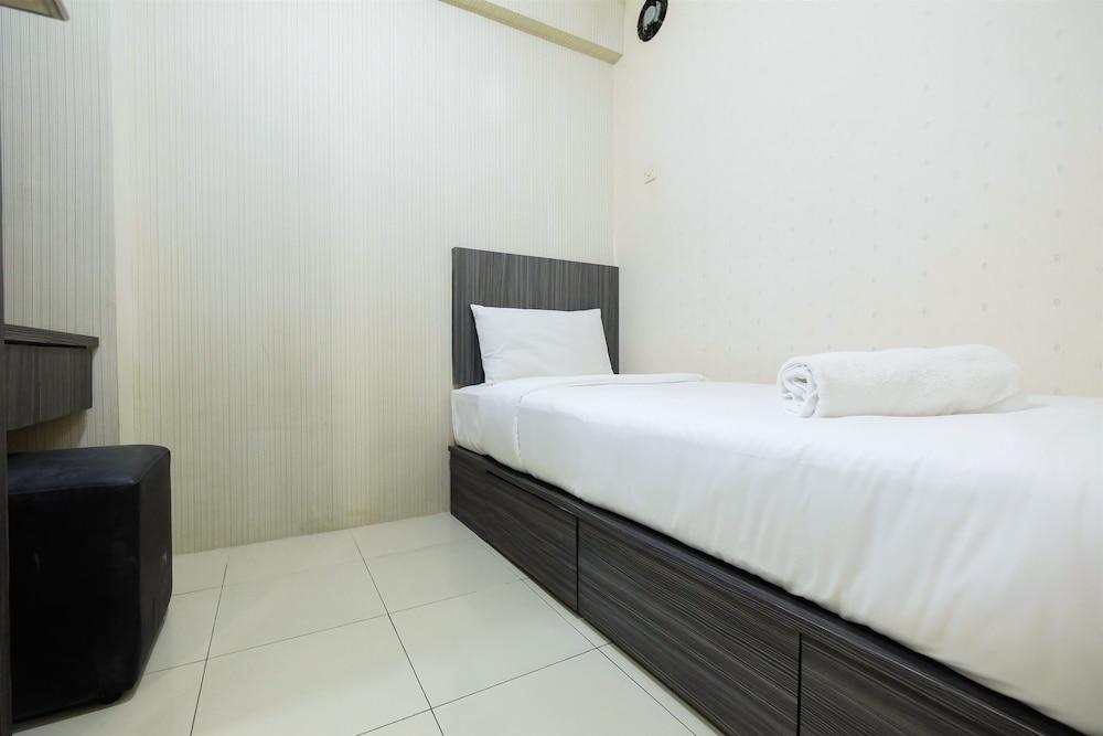 Monochrome Style 2 Bedrooms at Kalibata City Apartment By Travelio - Room